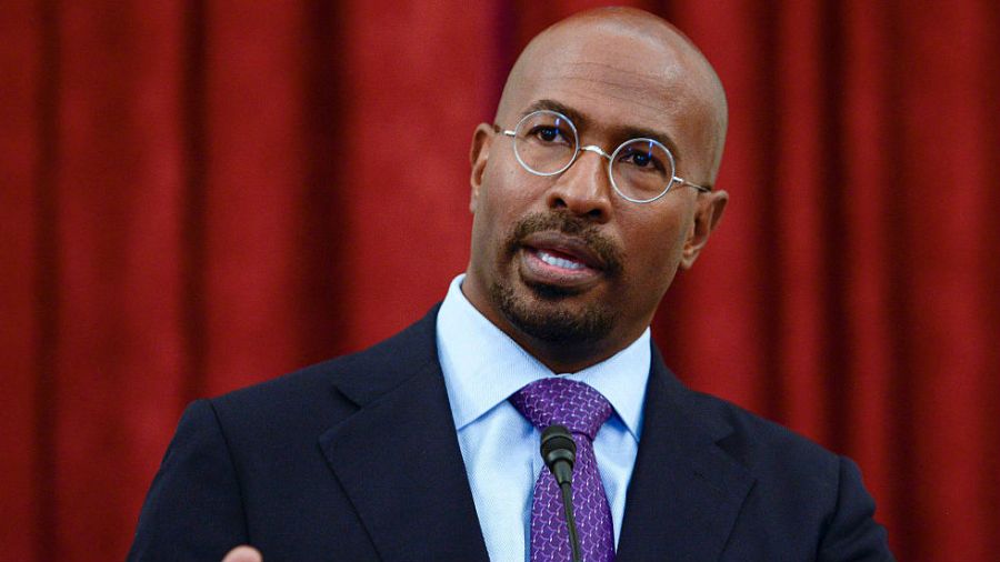 Van Jones is seen speaking in front of a red curtain.