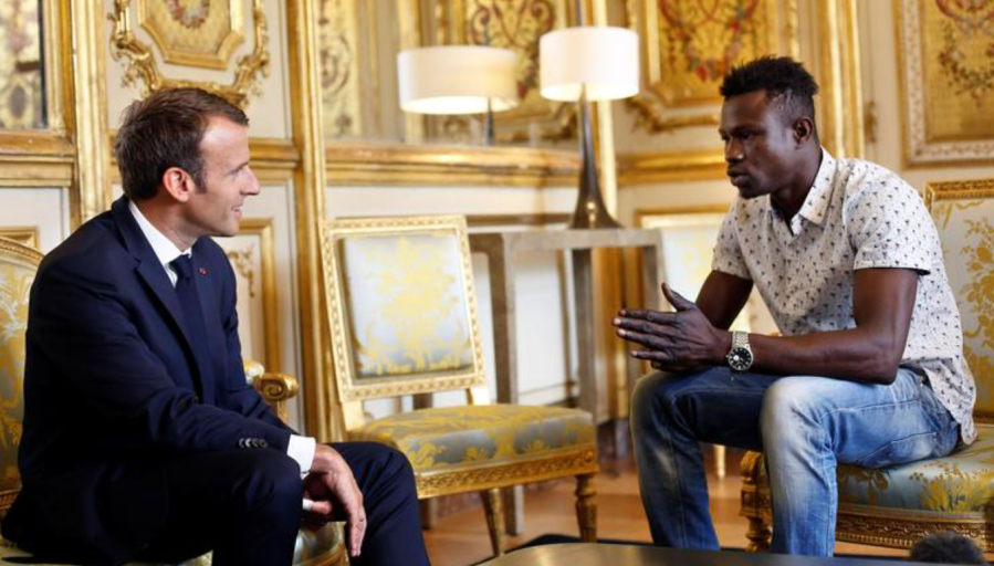 French President Emmanuel Macron (L) speaks with Mamoudou Gassama, 22, from Mali, at the presidential Elysee Palace in Paris, on May, 28, 2018. THIBAULT CAMUS—AFP/Getty Images