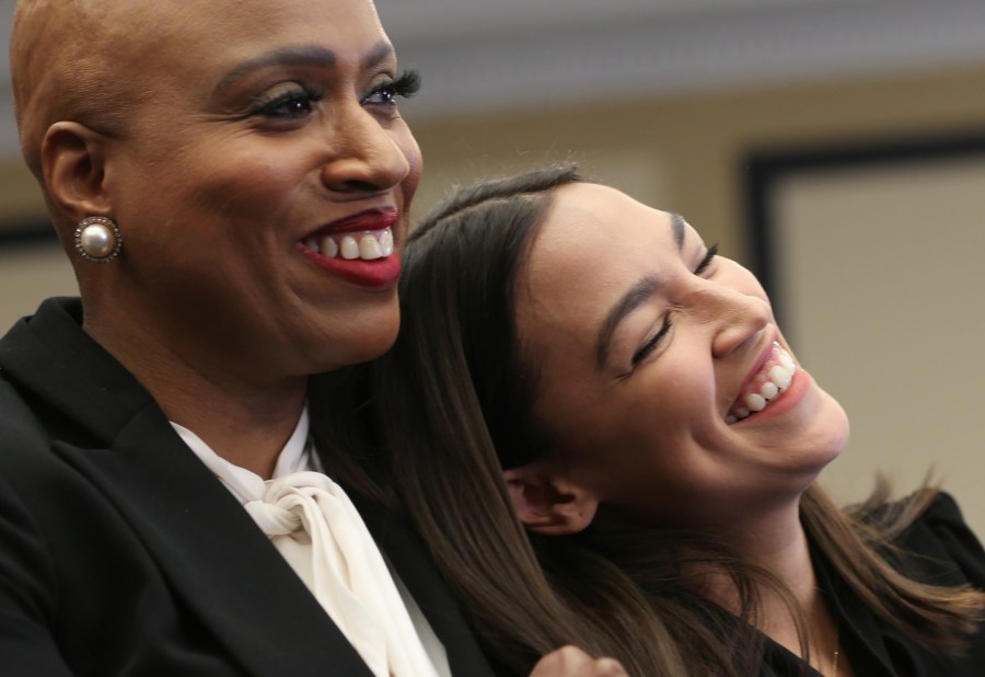 ayanna pressley sits with alexandria ocasio cortez