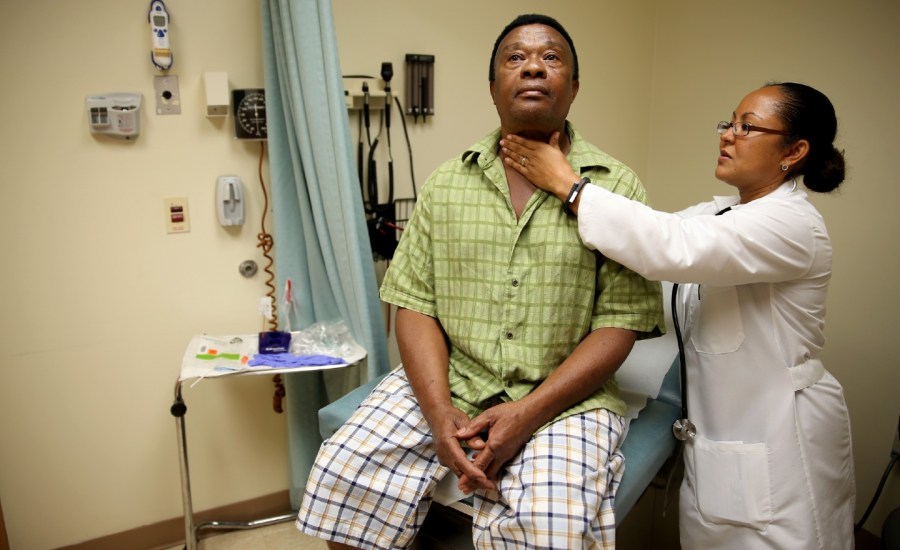 Felue Chang who is newly insured under an insurance plan through the Affordable Care Act receives a checkup from Dr. Peria Del Pino-White at the South Broward Community Health Services clinic on April 15, 2014 in Hollywood, Florida