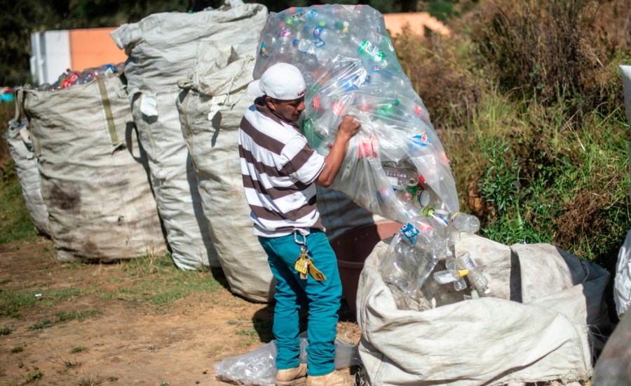 A recycling worker sorts plastic bottles