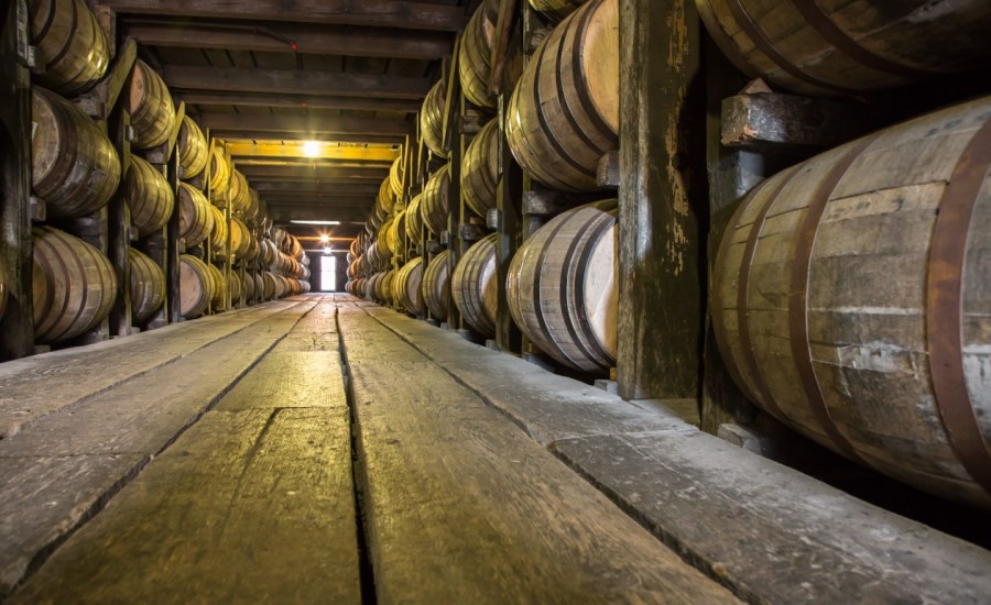 unmarked barrels of bourbon whiskey in a storage facility