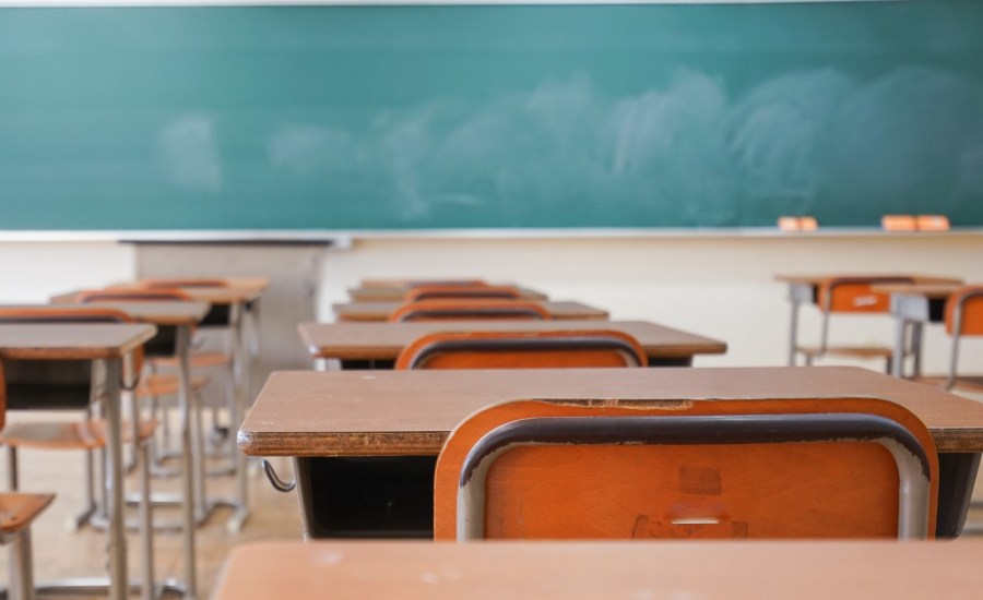 an empty school classroom and chalkboard