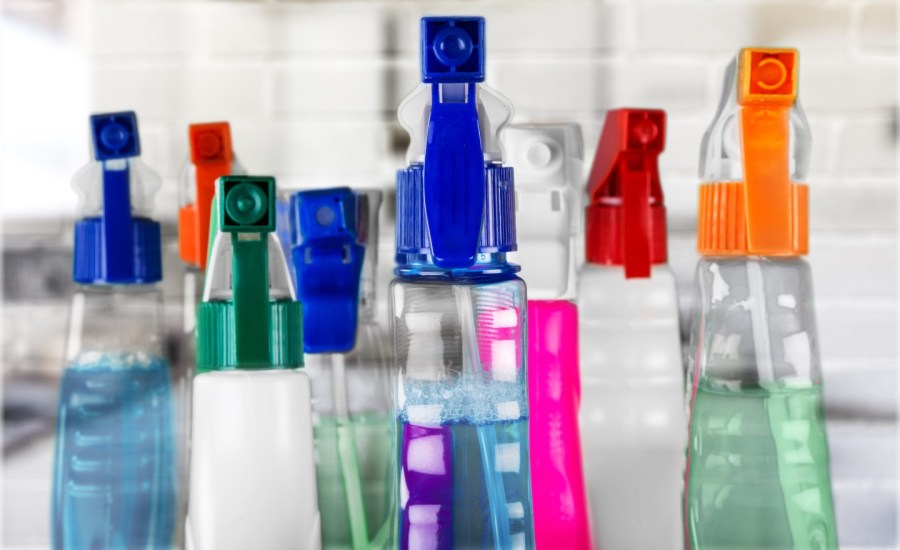 a collection of unidentified household cleaners in spray bottles