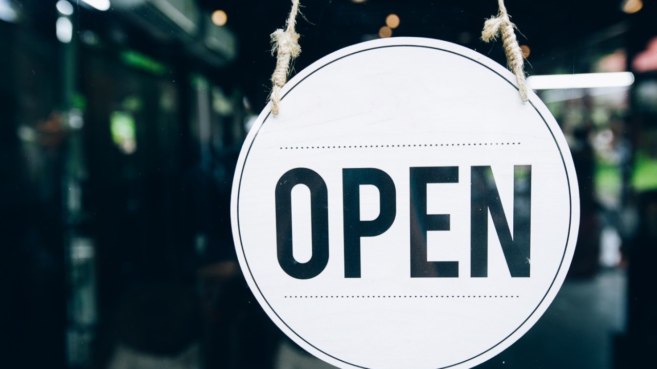 an open sign in front of a cafe