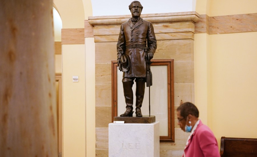 District of Columbia delegate to the House of Representatives, Eleanor Holmes Norton, walks past a statue of Robert E. Lee, commander of the Confederate States Army, in the Crypt of the US Capitol