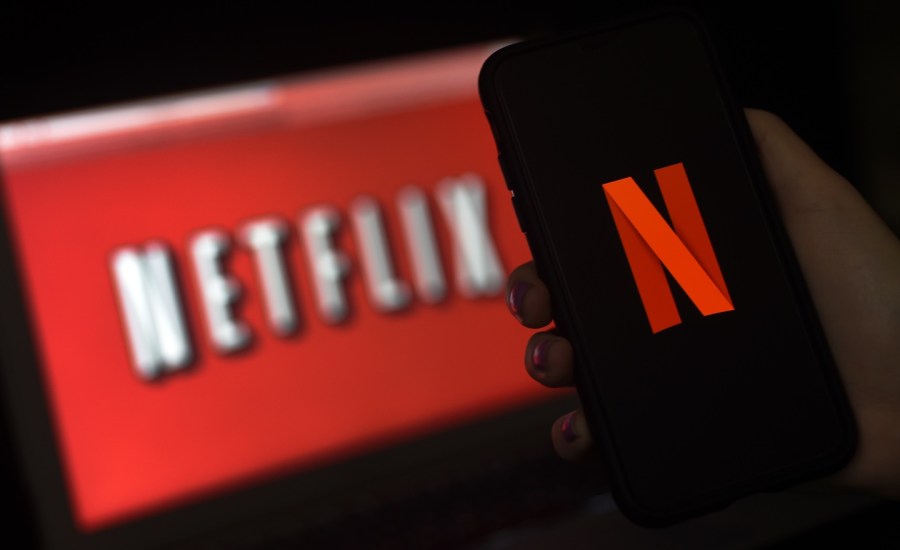 the Netflix logo on a laptop and phone screen