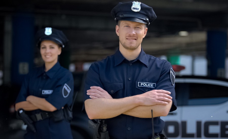 police smiling in front of a police station