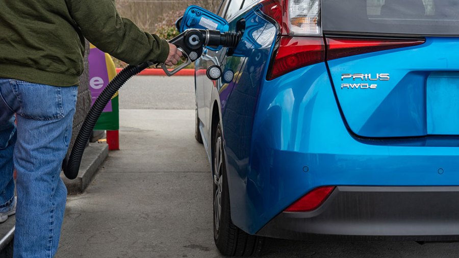 Electric car being charged at station