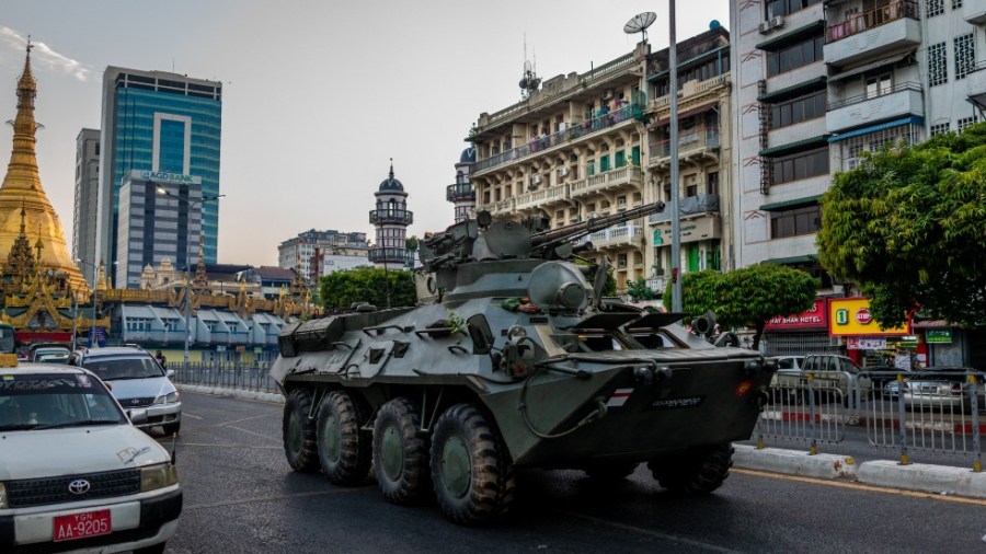 A military vehicle rolls down a street in Myanmar.