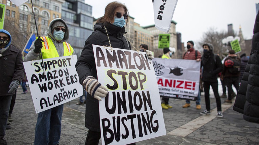 People hold signs supporting Amazon workers