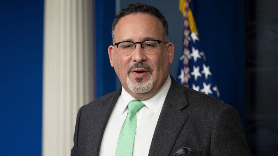 Education Secretary Miguel Cardona speaks with reporters at the White House