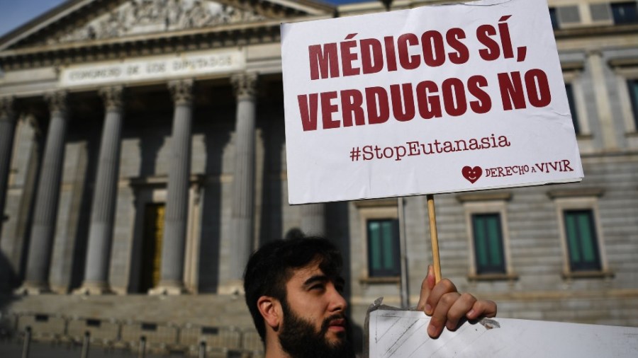 An anti-euthanasia protester in front of Spain's Parliament