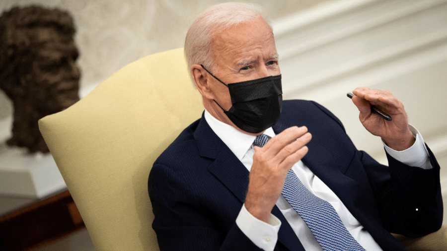 President Biden speaks with reporters in the Oval Office