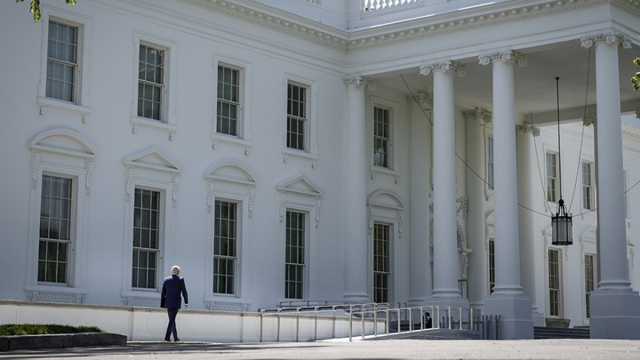 President Joe Biden walks to the White House