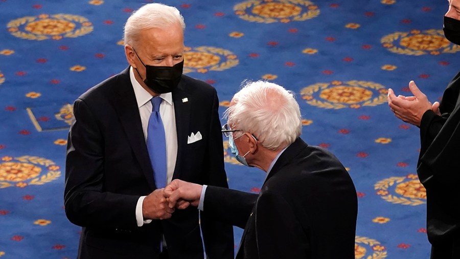 President Biden fist bumps Sen. Bernie Sanders (I-Vt.)