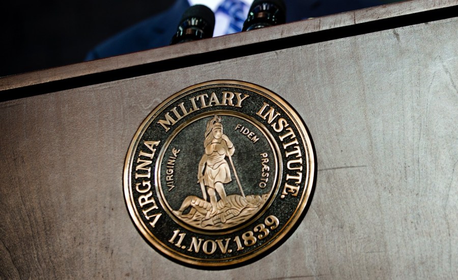 a podium with the seal of the virginia military institute, the date of its establishment (Nov 11, 1839) and motto "virginiae fidem praesto"