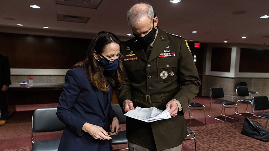 Director of National Intelligence Avril Haines speaks to Defense Intelligence Agency Director Lt. General Scott Berrier before a Senate Armed Services Hearing to examine worldwide threats