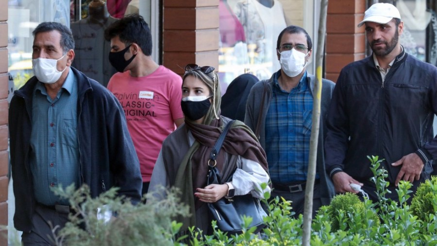 People walk on a street in Tehran