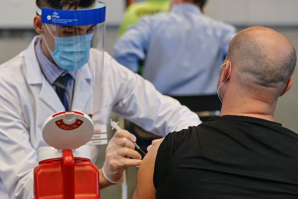 Vaccine shot being administered