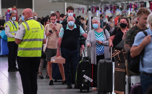 Airline passengers wait in line to check in at Sydney's Kingsford Smith domestic airport