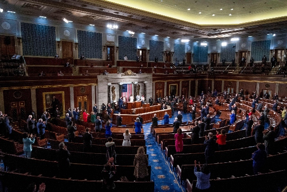 Socially distanced members of Congress stand as US President Joe Biden addresses a joint session of Congress