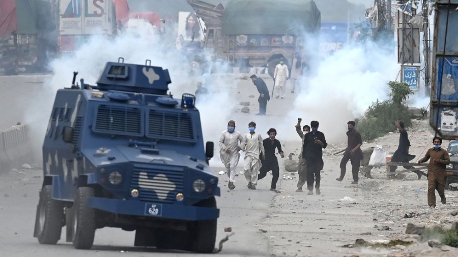 Supporters of Tehreek-e-Labbaik Pakistan (TLP) party throw stones