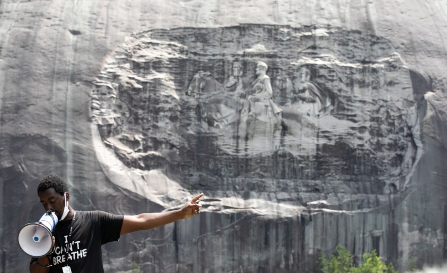 Organizer Quintavious Rhodes addresses Black Lives Matter protesters during a march in Stone Mountain Park to the Confederate carving etched into the stone side of the mountain on June 16, 2020 in Stone Mountain, Georgia.