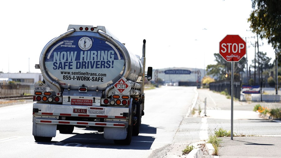 A gas truck with "Now Hiring Safe Drivers" printed on its back