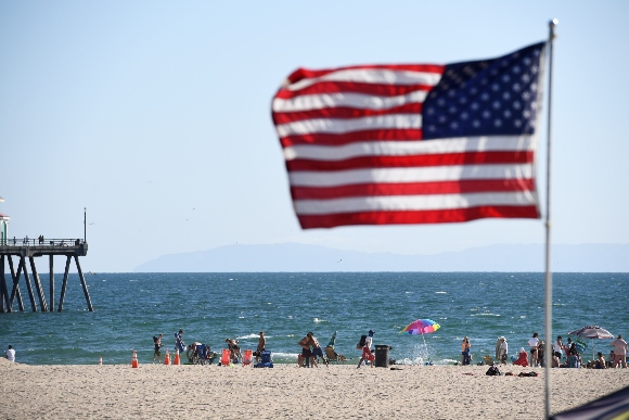 People enjoy the ocean, July 16, 2020 in Huntington Beach, California