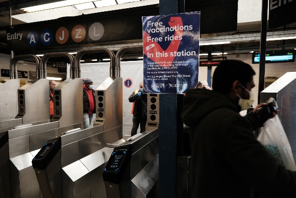 People move through the Broadway Junction subway station in Brooklyn