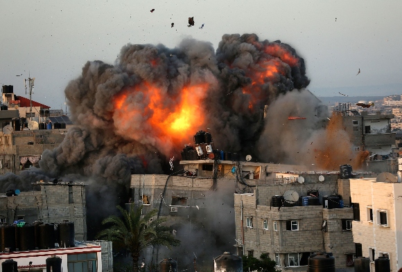 A ball of fire erupts from a building in Gaza City's Rimal residential district