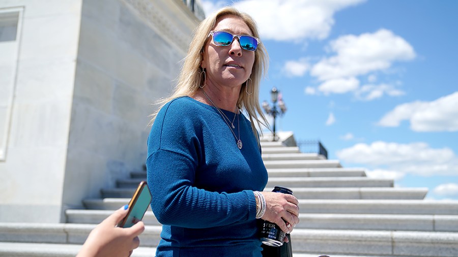 Rep. Majorie Taylor Greene (R-Ga.) speaks to reporters on her way to a vote series on May 13