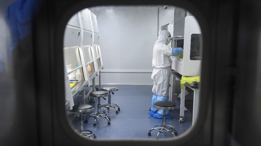 A laboratory technician works on samples to be tested for the novel coronavirus at the "Fire Eye" laboratory in Wuhan, China