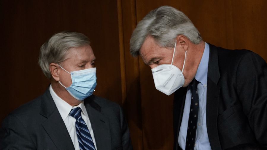 Sens. Lindsey Graham (R-S.C.) and Sheldon Whitehouse (D-R.I.) confer ahead of a Senate Judiciary Committee hearing