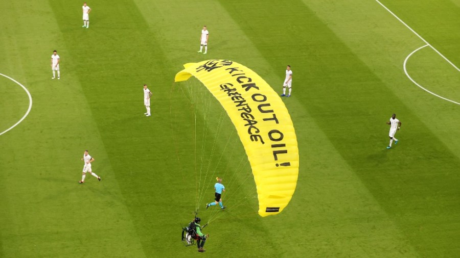 A Greenpeace protester parachutes into a Euro 2020 match