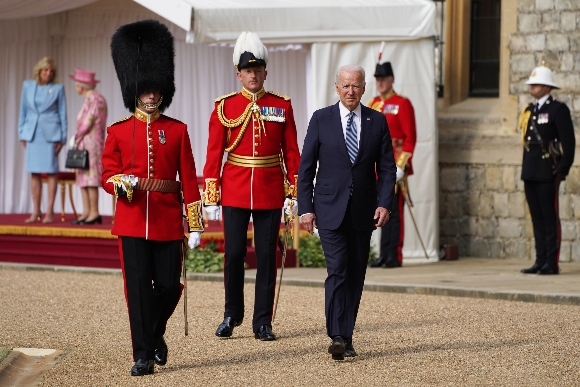 President Joe Biden inspects a Guard of Honour during a visit to Windsor Castle