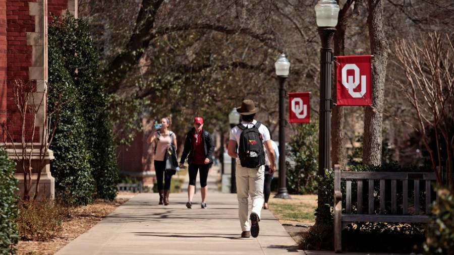 Students walk on campus between classes at the University of Oklahoma in Norman