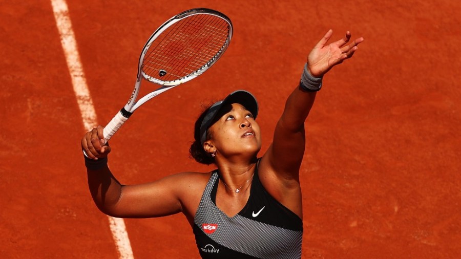 Naomi Osaka of Japan serves against Patricia Maria Tig of Romania at the French Open