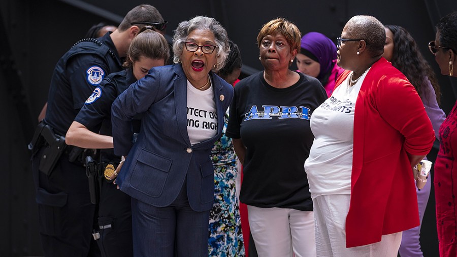 Rep. Joyce Beatty (D-Ohio) shouts slogans in support of voting rights while being arrested during a protest in the atrium of Hart Senate Office Building on July 15