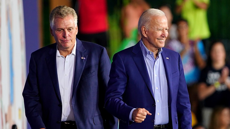 President Biden and Virginia Democratic gubernatorial candidate Terry McAuliffe leave the stage after speaking to supporters at a grassroots campaign event at Lubber Run Park in Arlington, Va., on Friday, July 23, 2021.