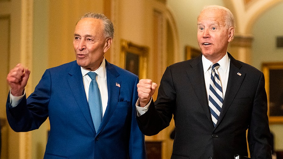 Majority Leader Charles Schumer (D-N.Y.) leads President Biden as he arrives to the Capitol for a luncheon with Senate Democrats to discuss an infrastructure plan on Wednesday, July 14, 2021.