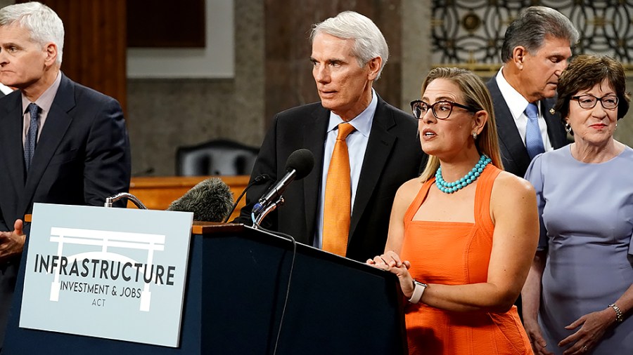 Sens. Rob Portman (R-Ohio) and Kyrsten Sinema (D-Ariz.) addresses reporters after a key vote regarding bipartisan infrastructure legislation on Wednesday, July 28, 2021.