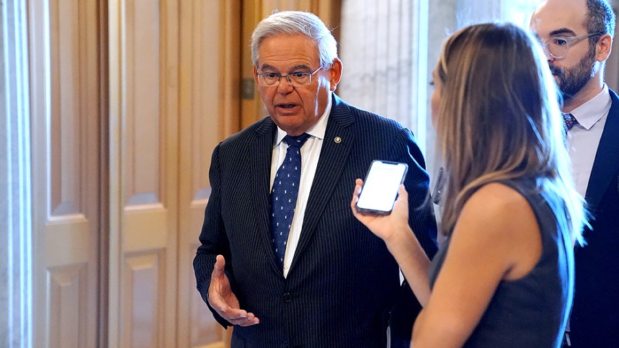 Sen. Robert Menendez (D-N.J.) speaks to a reporter as he arrives for a vote on July 13