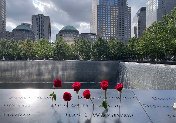 Roses are left in memory of the victims on the 9/11 memorial, in New York