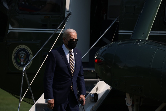 President Joe Biden walks off Marine One after returning to the South Lawn of the White House