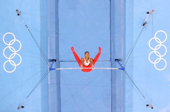 Joe Fraser of Team Great Britain competes on the horizontal bar 