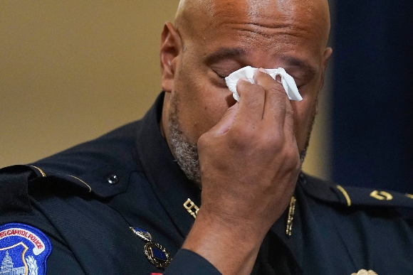 US Capitol Police officer Harry Dunn wipes his eyes during testimony