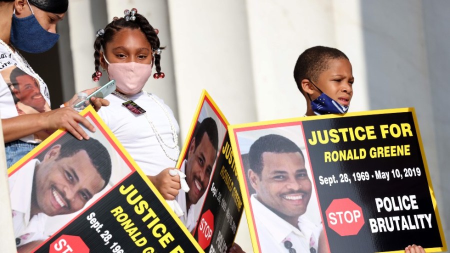 Family members of the late Ronald Greene listen to speakers during at protest against racism and police brutality in Washington, D.C.