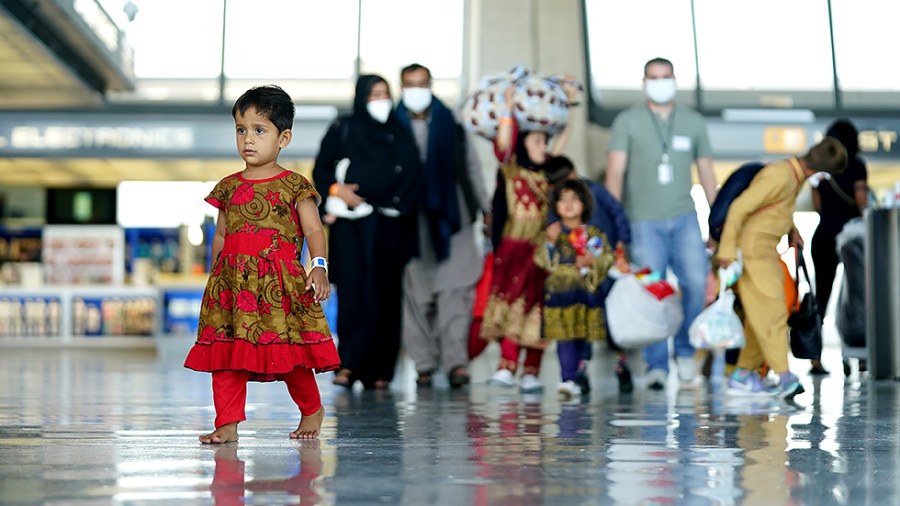 Afghan refugees displaced from their homes due to the Taliban takeover arrive at Washington Dulles International Airport in Chantilly, Va., on Monday, August 30, 2021.